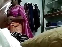 A hot Indian aunty wears a saree while she is alone in dramatize expunge house A spy cam records her ever after move and we see her unbutton her blouse and expose her big melons